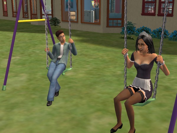 Liam sits on the swings with Kaylynn